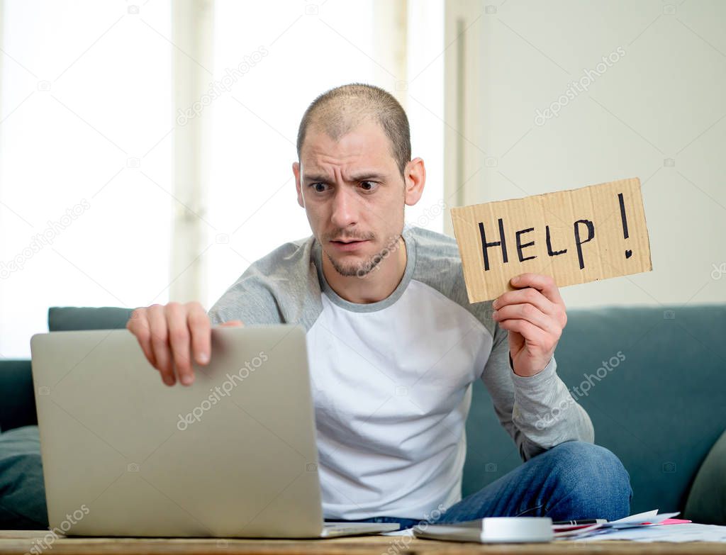 Attractive young man overwhelmed with business and home finances asking for help paying expenses in living cots stress paying bills problem credit card debts mortgage and bad financial situation.