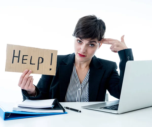 Tired and frustrated young attractive business woman working on computer holding desperate a help sign at office isolated on white background. Coping with Stress and frustration at work concept.