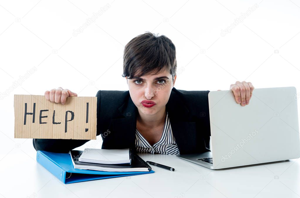 Tired and frustrated young attractive business woman working on computer holding desperate a help sign at office isolated on white background. Coping with Stress and frustration at work concept.
