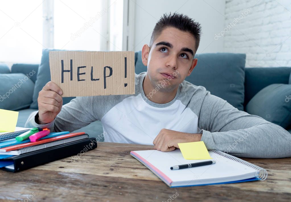 Young tired and stressed student working on his homework, masters feeling desperate and frustrated asking for help. In over Education, learning difficulties, finals exams and emotional stress concept.