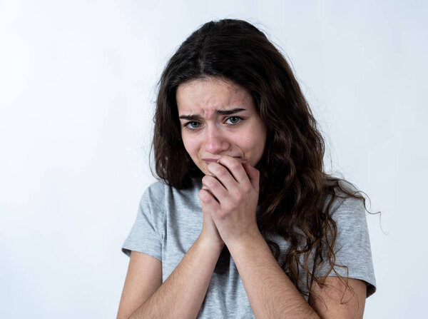 Close up portrait of scared and shocked young teenager female Looking surprised with fear in her eyes. People and Human expressions and emotions concept. isolated on white.