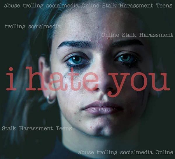 Dramatic closeup portrait of upset desperate girl bullied online suffering harassment crying and feeling intimidated. Child victim of cyberbullying,stalker, social media and dangers of the Internet.