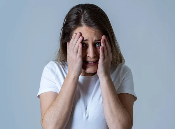 Close up of young woman feeling scared and shocked making fear, anxiety gestures. Looking terrified and desperate. People and Human expressions and emotions concept. Isolated on neutral background.