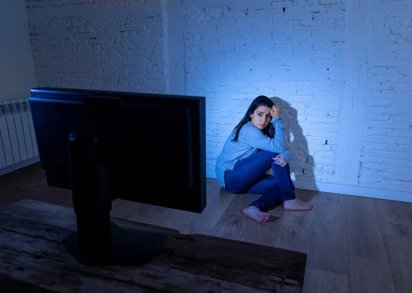 在地面上 悲伤的年轻女子的戏剧性画像盯着一台遭受网络欺凌和骚扰的电脑 在网上被跟踪者虐待 感到绝望 互联网概念的危险 — 图库照片