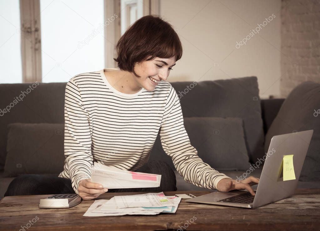 Happy woman with laptop feeling successful accounting home finances calculating costs, charges, mortgage, taxes and paying bills. In e-banking, e-commerce and home or small business accountant.