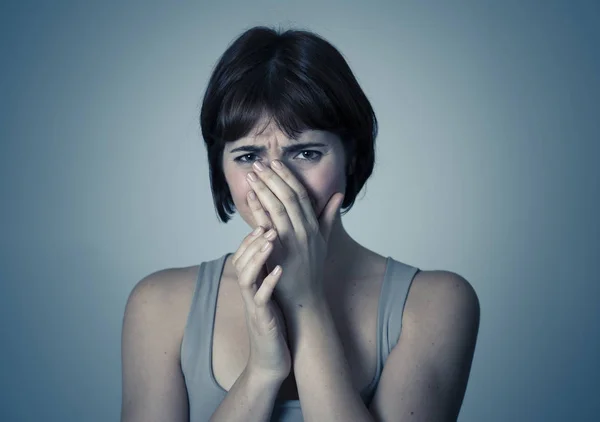 Portrait of young woman feeling scared and shocked making fear, anxiety gestures. Looking terrified and desperate. People and Human expressions, aggression, domestic violence and victim concept.