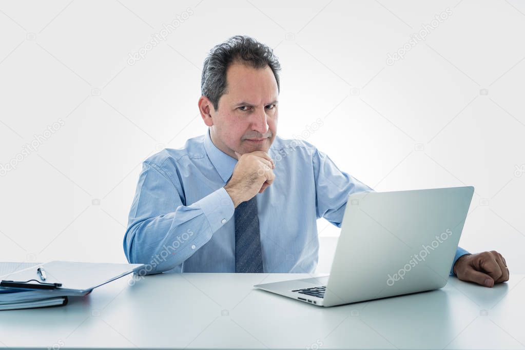 Angry and frustrated middle aged businessman overworked, upset and frustrated having too much work and staying extra hours at office. In Overtime, stress at work concept isolated in white background.