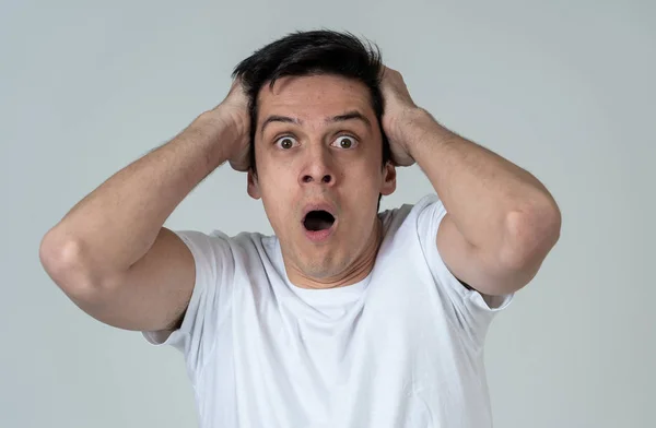 Young man feeling scared and shocked making fear, anxiety gestures. Looking terrified and desperate trying to cover himself. Portrait with copy space. People and Human expressions and emotions.