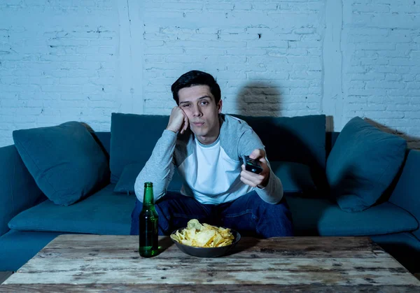 Junger Gelangweilter Mann Auf Der Couch Mit Fernbedienung Zappen Für — Stockfoto