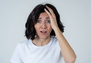 Korkmuş gözleri ile Latin kadın yakın, korku, anksiyete jestleri yapma şok. Korkmuş ve çaresiz görünüyor. İnsanlar ve İnsan ifadeleri ve duygular kavramı. Nötr arka planda yalıtılmış.