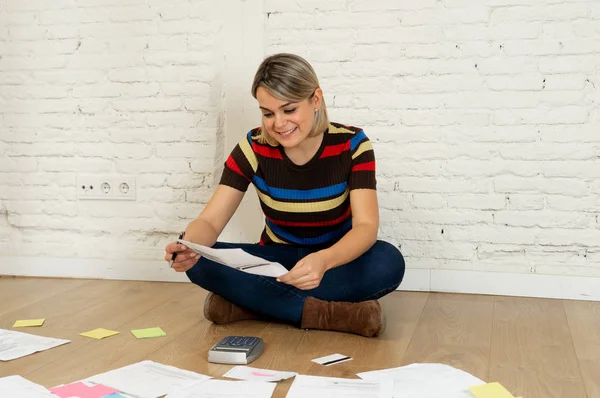 Happy Young Woman Sitting Floor Surrounded Papers Calculating Costs Charges — Stock Photo, Image