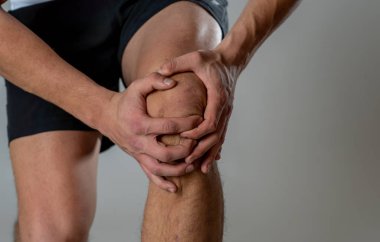Genç fit adam kas yaralanması zarar kemik bacak ağrısı burkulma veya kramp çalışan egzersiz sırasında acı elleri ile diz tutarak. İçinde vücut ağrısı ve spor eğitim yaralanma ve vücut sağlık bakımı.
