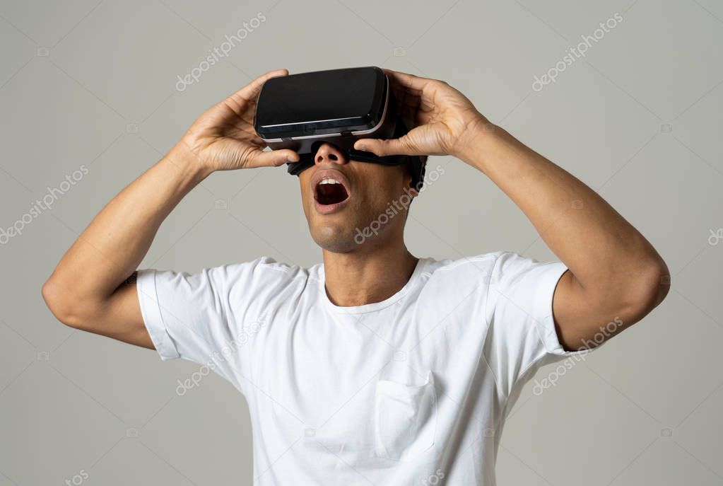 Amazed african american man using VR headset glasses, feeling excited about simulation, exploring virtual reality making gestures interacting with new virtual world. In new technology concept.