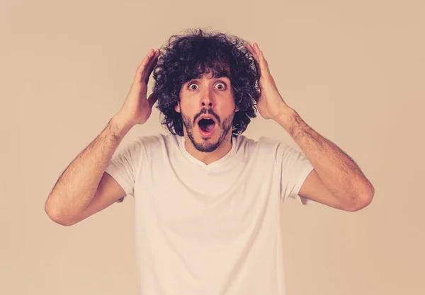 Portrait of funny attractive young man with happy and surprised face pointing and looking excited at something shocking and good. Human emotions, facial expressions. Advertising, sales or winning.