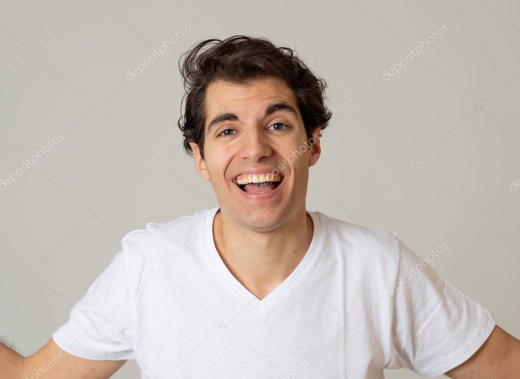 Close up portrait of happy young caucasian latin man wearing white T-shirt. Smiling feeling satisfied and confident. With copy space. People, positive human facial expressions and emotions concept.