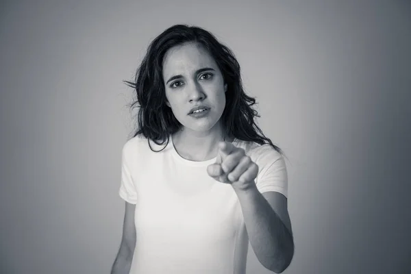 Close up of young attractive frustrated latin woman in stress with furious face. Looking mad and disappointed making angry gestures. In neutral background. In human facial expressions and emotions.