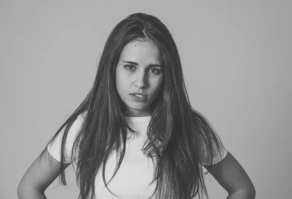 Close up of young attractive frustrated latin woman in stress with furious face. Looking mad and disappointed making angry gestures. In neutral background. In human facial expressions and emotions.