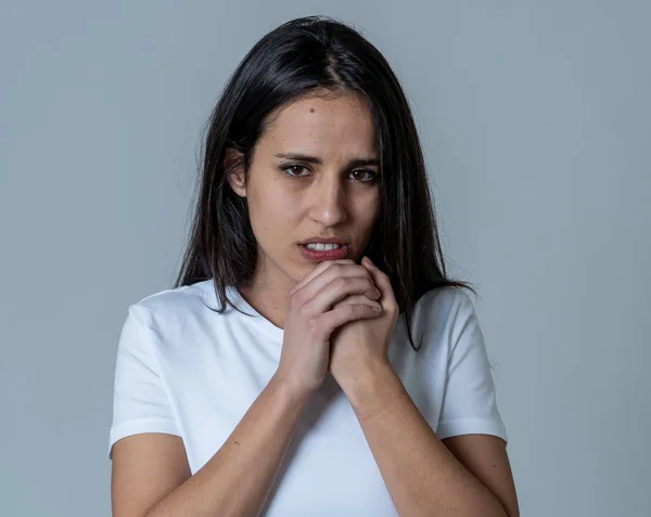 Portrait of a young sad woman, serious and concerned, looking worried and thoughtful. Feeling emotional pain, sorrow and depression. With copy space. In facial expressions and human emotions concept.