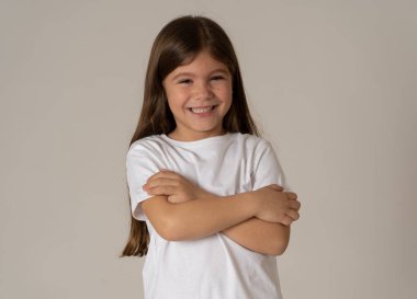 Sevimli mutlu, kendine güvenen, başarılı, gururlu küçük kız kameraya gülümsüyor. Olumlu insan duyguları ve yüz ifadeleri, çocuk ve eğitim kavramı. Kopya alanı ile stüdyo çekimi.