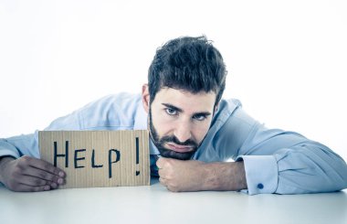 Desperate and frustrated caucasian young businessman holding message asking for help feeling exhausted distressed and sad in Unemployment, Depression, Stress at work place and overwork concept. clipart