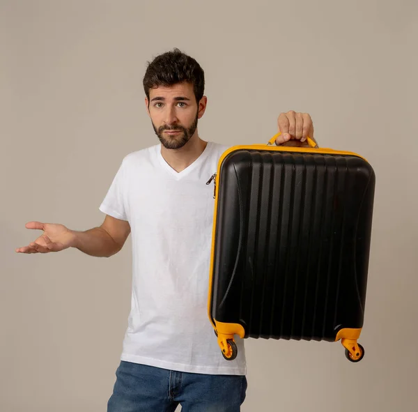 handsome young man with suitcase in studio