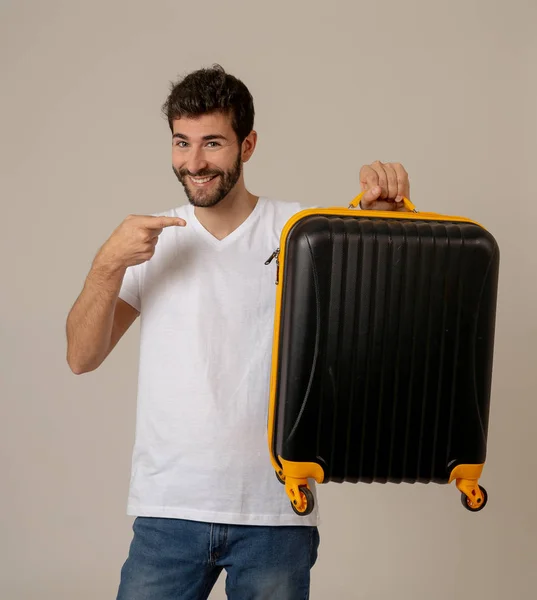 handsome young man with suitcase in studio