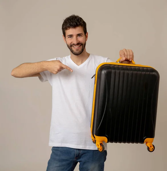 handsome young man with suitcase in studio