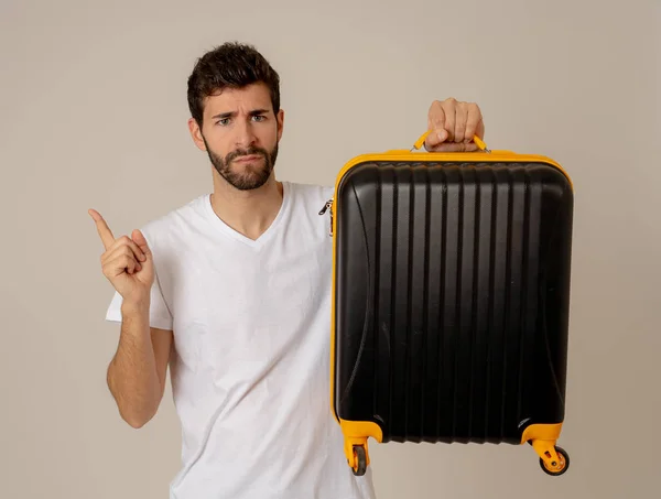 handsome young man with suitcase in studio