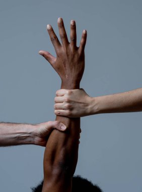 Black African American and Caucasian hands holding together. White and black skin arms in world united against racism, racial love and understanding races diversity and Human rights cooperation concept clipart