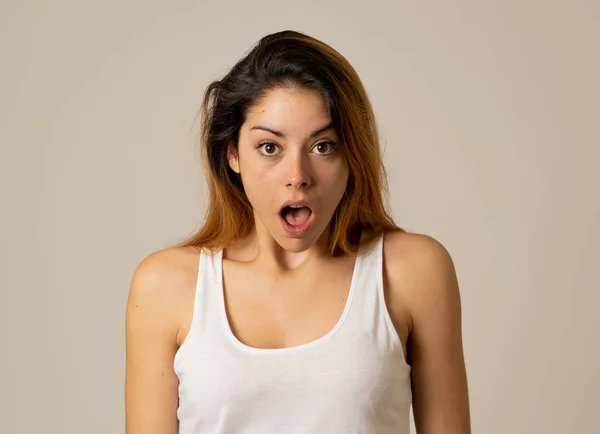 Beautiful young blonde woman with happy face making surprised gestures looking at something shocking and good. Human facial expressions and emotions. Portrait with copy space.