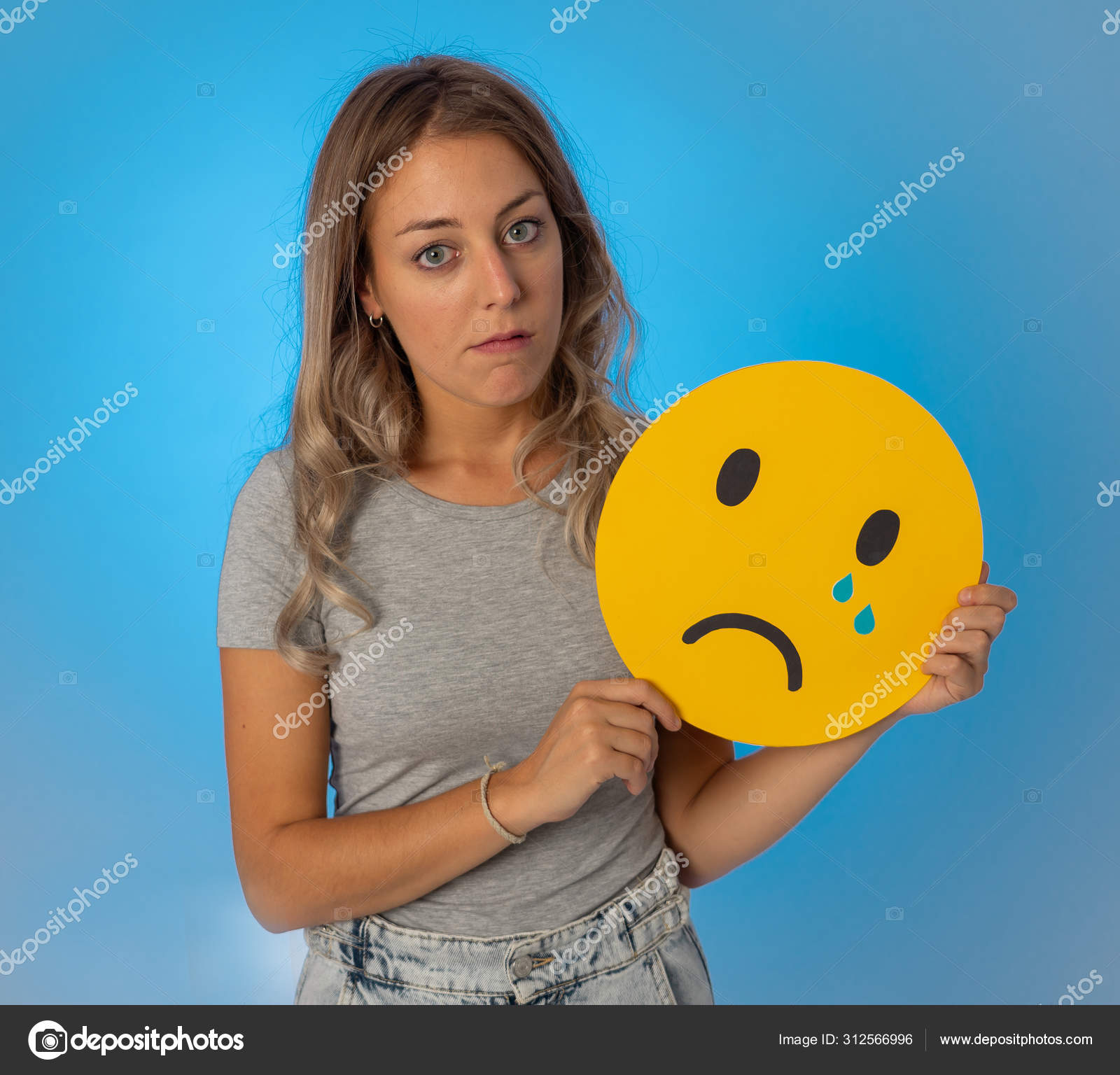Download A Woman Holding A Sad Face On Her Face