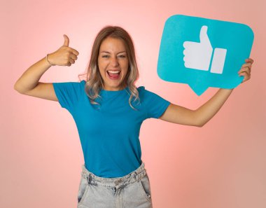 Beautiful young woman holding Like symbol social media notification icon asking followers to like her online comments, blog or business. In Internet obsession, networking and technology connections. clipart