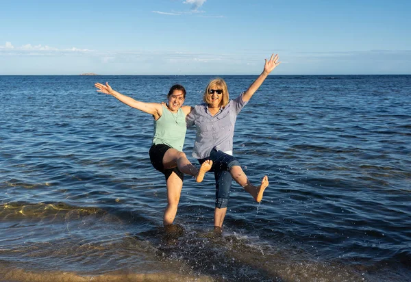 大妈妈和大女儿在偏远的海滩上享受户外生活 在放松了对考拉病毒的封锁后一起度过了一段时光 幸福的家庭 健康活跃的人和希望的概念 — 图库照片