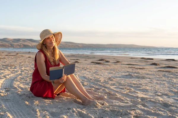 Happy Attractive Mature Woman Red Dress Reading Relaxing Empty Beach — Stock Photo, Image