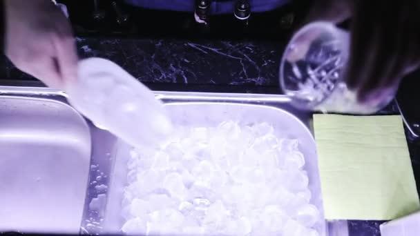 Close-up of a man with a shovel takes ice crush for a cocktail. — Stock Video