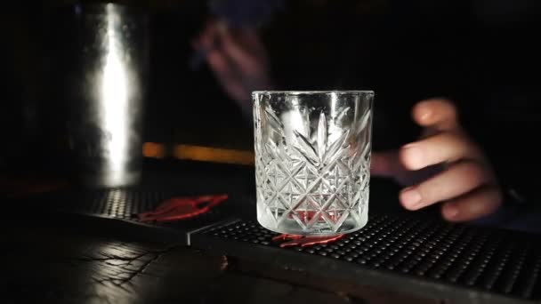 The bartender pours milk through a sieve into a glass. — Stock Video