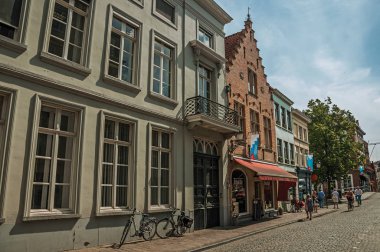 Bruges'te insanlarla, tuğla evlere ve dükkanlarla sokak