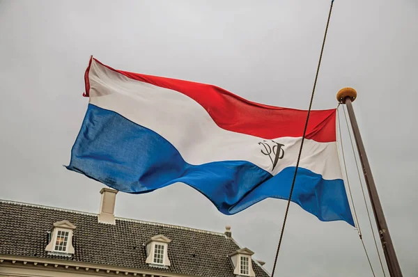 Colorful Dutch East India Company flag fluttering in Amsterdam