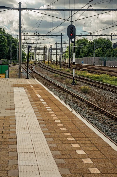 Platform, rails and signaling at train station of Weesp