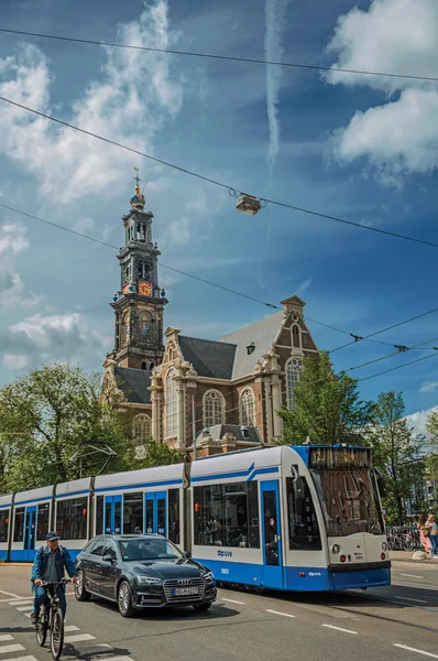 Οδός με παλιά εκκλησία, ποδηλάτης και τραμ στο Άμστερνταμ — Φωτογραφία Αρχείου