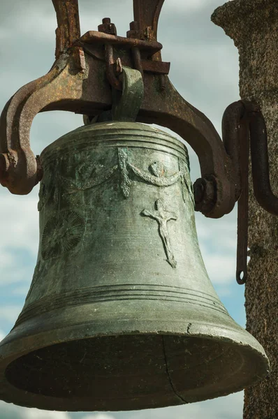 Close-up of bronze bell where can be seen details carved on the surface, at the Castle of Trujillo.