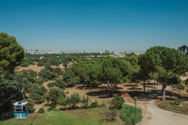 Madrid Teleferico Parkı'nda ağaçların arasından geçen teleferik gondol