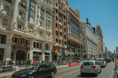 Madrid'de insanlarla ve arabalarla işlek sokakta binalar