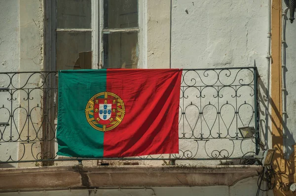 Portuguese flag on top of iron handrail of balcony — Stock Photo, Image