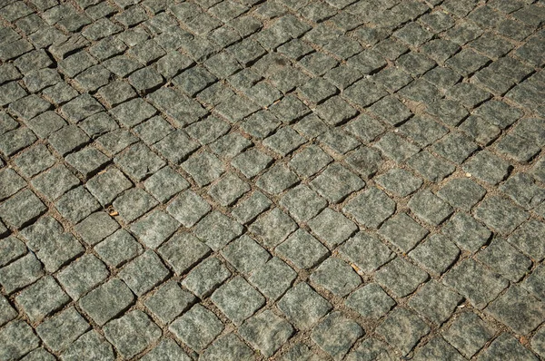 Primo piano di pavimentazione fatta di set di granito sul vicolo — Foto Stock