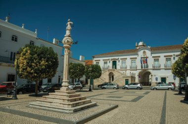 Meydanda heykel li mermer pillory ve arkada Belediye Binası