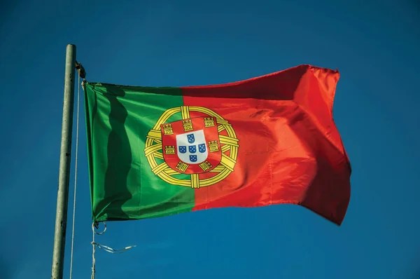 Portuguese flag fluttering in the blue sky — Stock Photo, Image