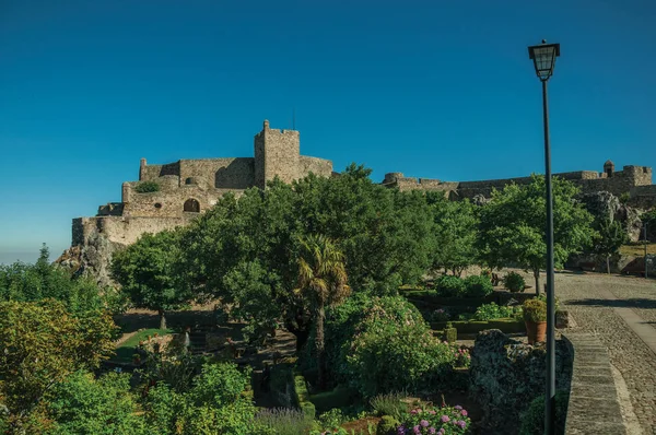Marvao'da bahçeye yakın taş duvarlar ve kale kulesi