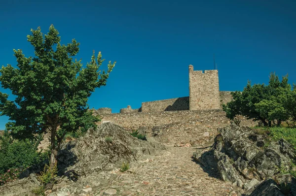 Cobblestone sidewalk to the stone wall of the Marvao Castle