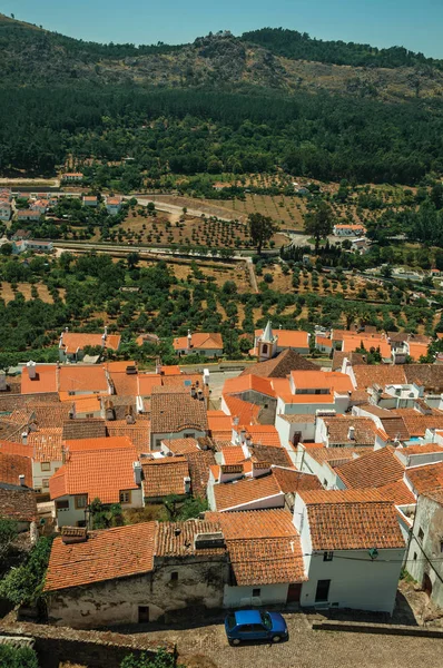 Cityscape with old building roofs and green hills — Stock Photo, Image